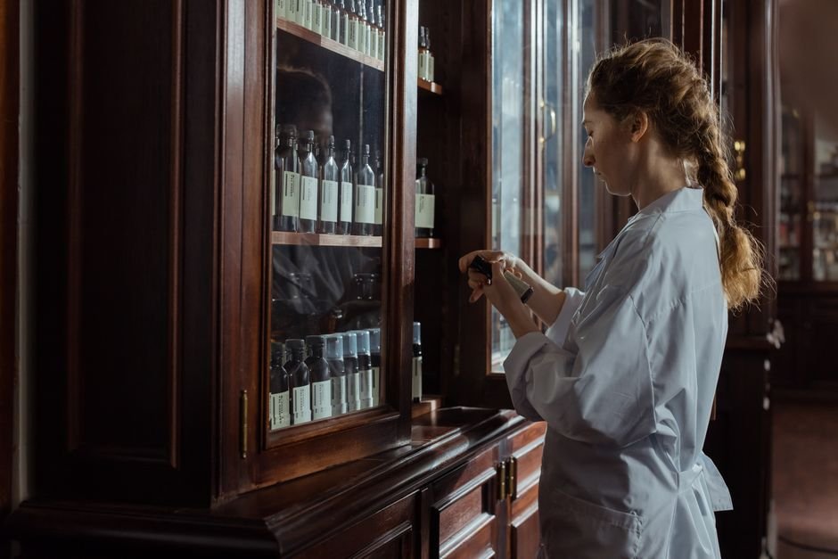 A pharmacist organizing medication in a pharmacy